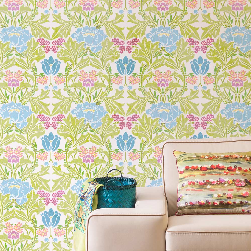 William morris Acanthus Floral wall stencil with a couch and decorative pillow in a room setting
