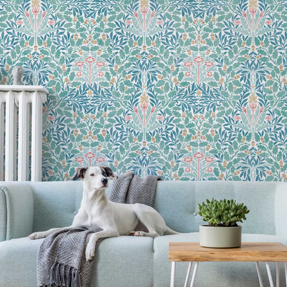Dog sitting on a light blue sofa with patterned William Morris Wall stencil in the background
