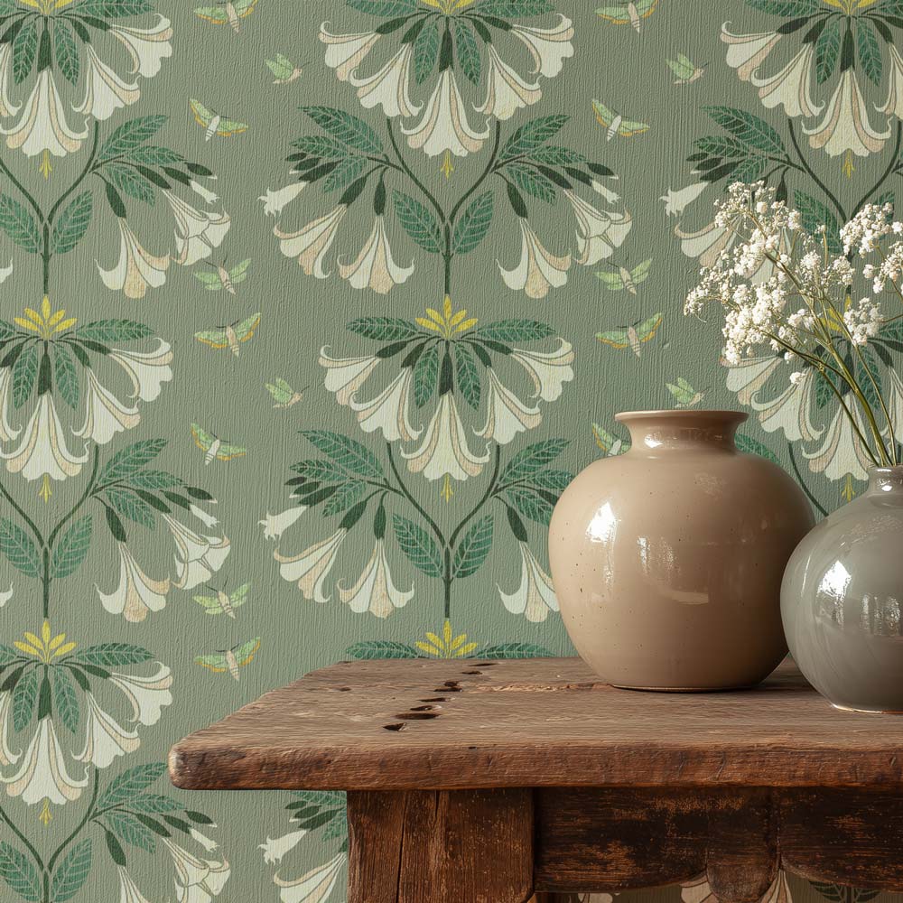 Floral wallpaper with a wooden table and two vases.