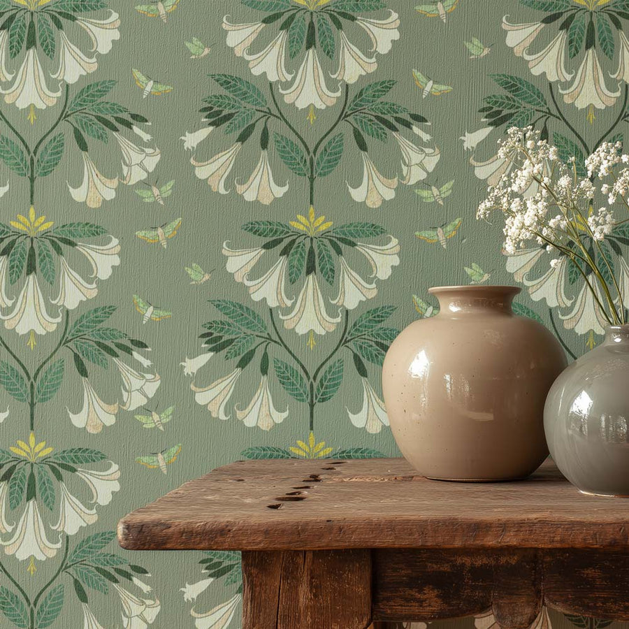 Floral wallpaper with a wooden table and two vases.