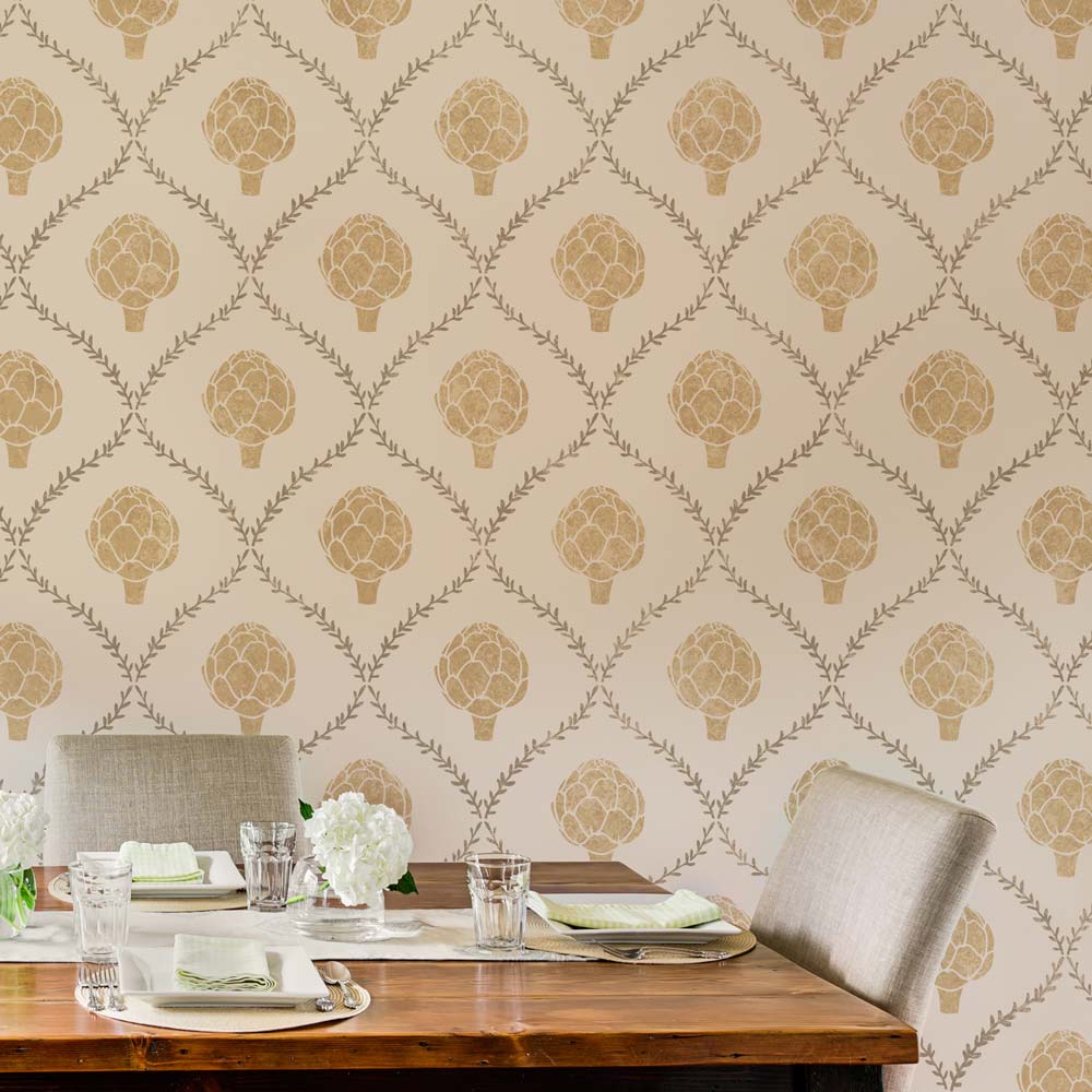 Dining table set against a wall with decorative stencil featuring artichoke and rosemary patterns.