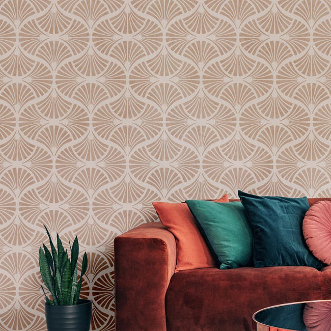 Patterned stenciled wall with a red sofa and colorful cushions