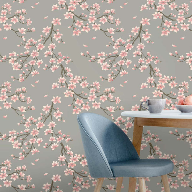 Magnolia blossom wallpaper with a blue chair and table in the foreground