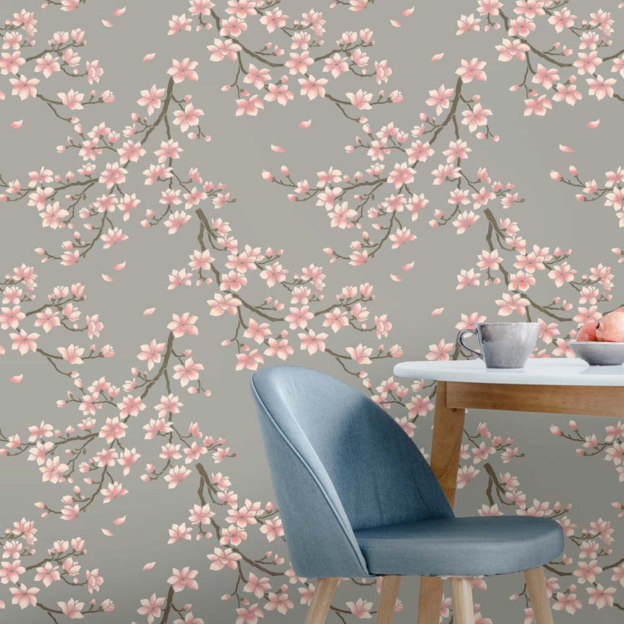 Magnolia blossom wallpaper with a blue chair and table in the foreground
