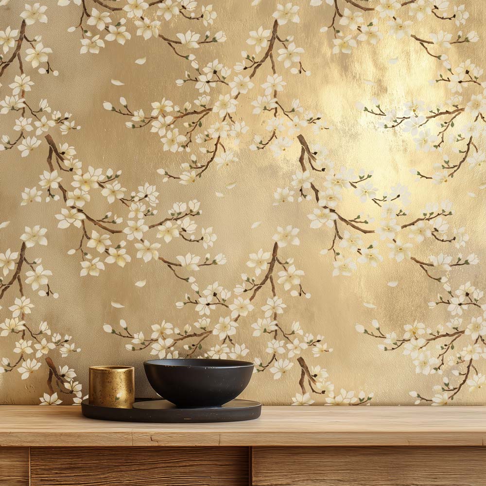 Decorative wall stencil with magnolia blossom design on a gold wall with a wooden shelf below.