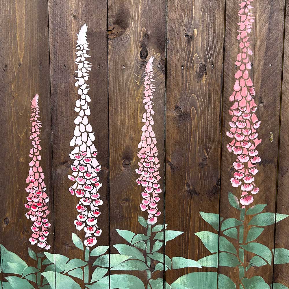 Hand-painted foxglove flowers on a wooden background stenciled fence