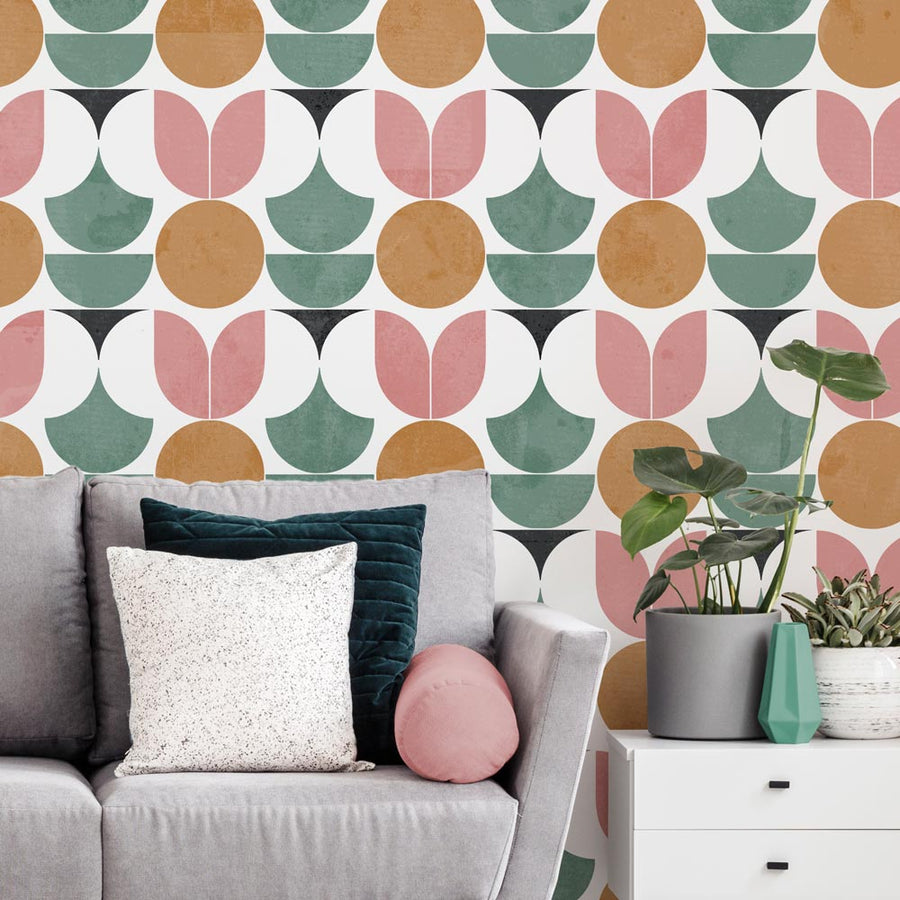 Abstract geometric stencil pattern featured in muted colors on a wall