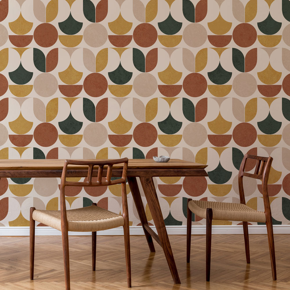 Dining table with chairs against a geometric patterned stencil wall.