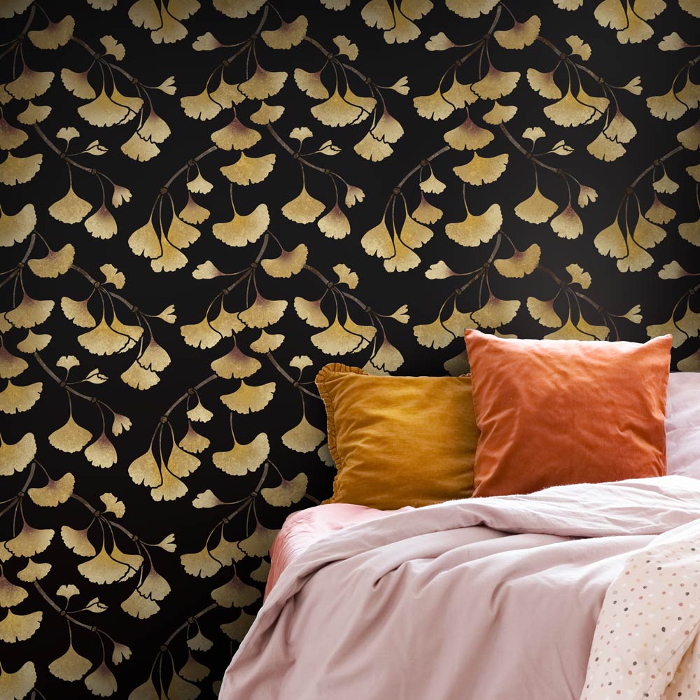 Pink bed with gold ginkgo leaf patterned wall stencil
