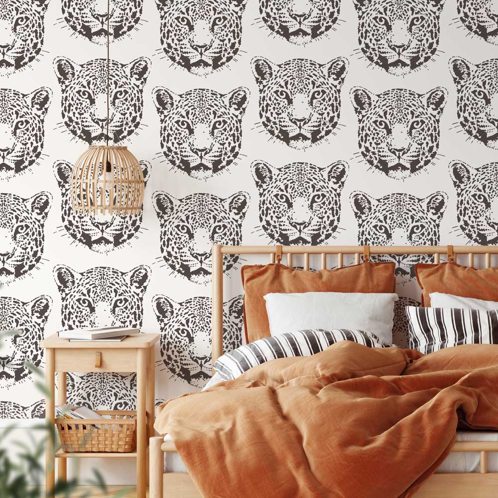 Bedroom with jaguar stencil pattern wallpaper and orange bedding