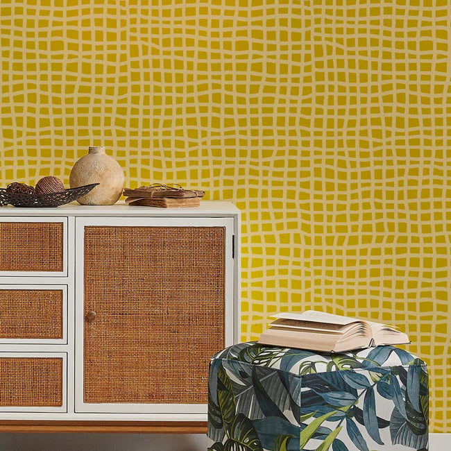 Cabinet with woven doors against a yellow patterned wall