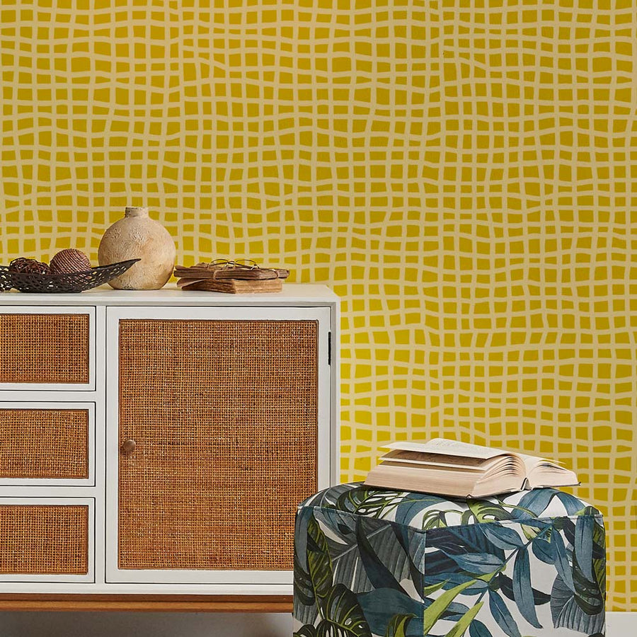 Cabinet with woven doors against a yellow patterned wall