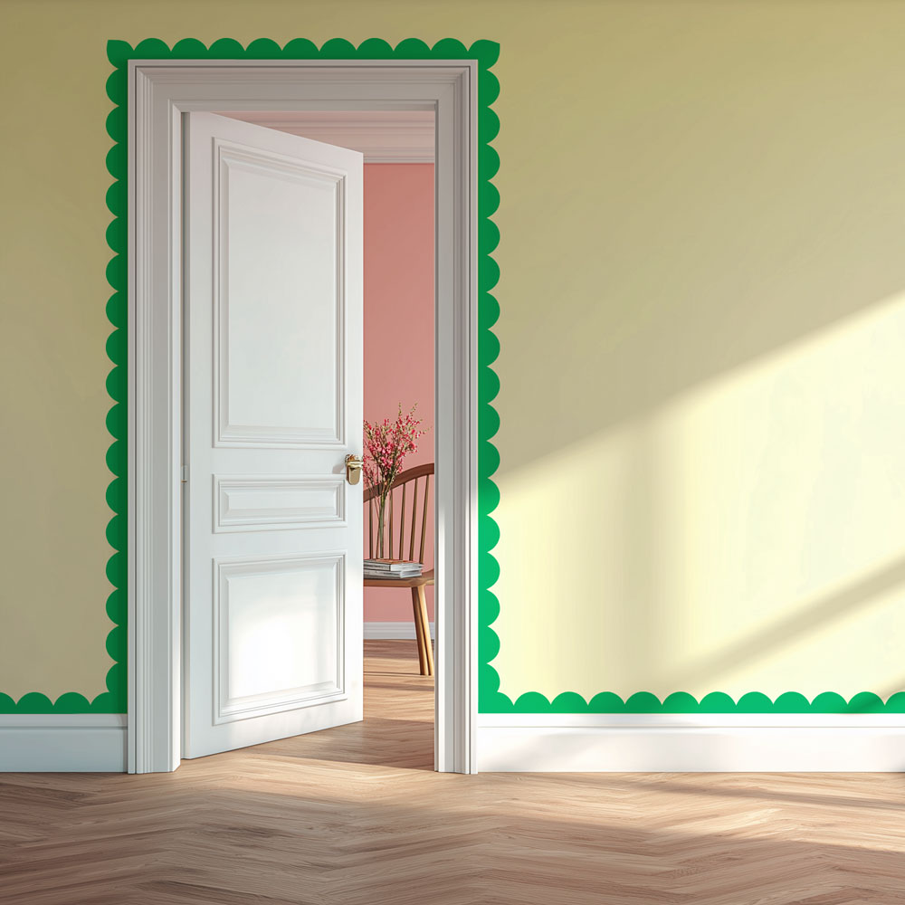 Open door with green decorative stenciled scallop trim on a yellow wall