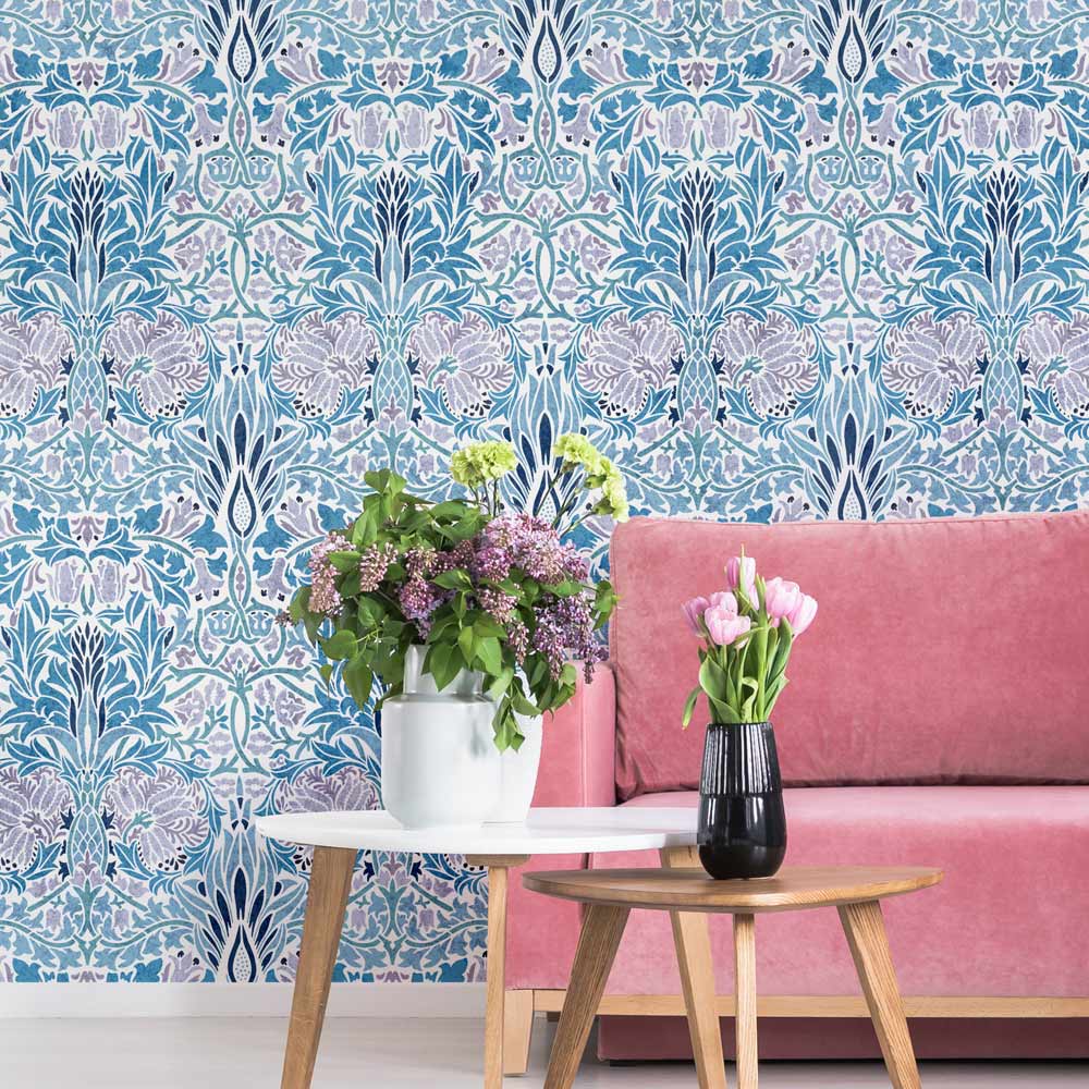 Living room with pink sofa, floral table, and decorative william morris wall stencil in blue