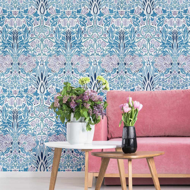 Living room with pink sofa, floral table, and decorative william morris wall stencil in blue