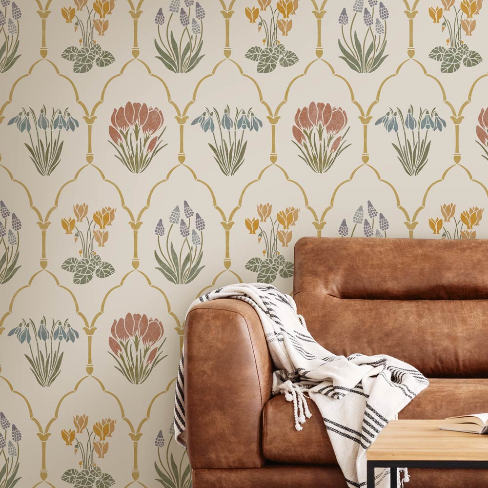 Brown sofa with a patterned wall stencil featuring floral designs.