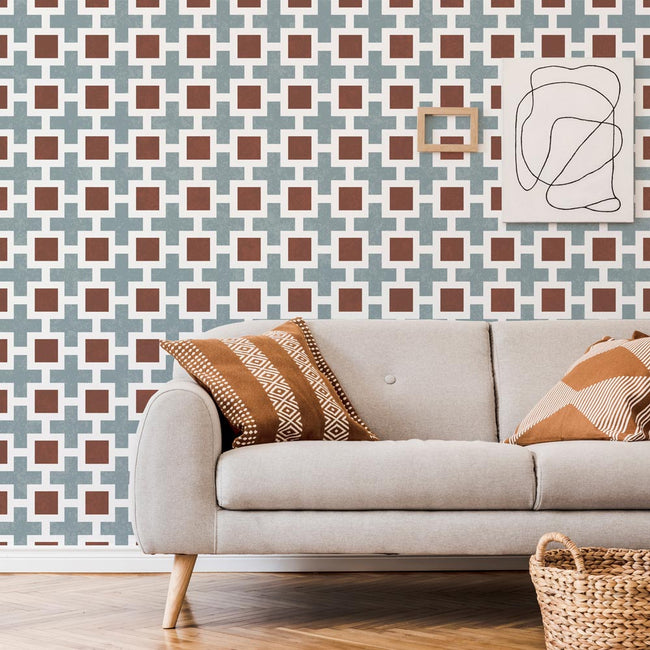 Living room with a beige sofa, patterned stencil wall, and abstract art.