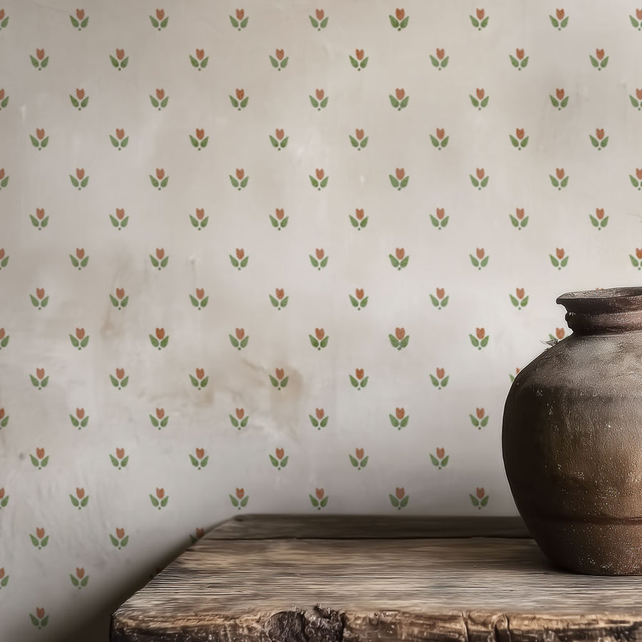 Decorative wall stencil with small floral pattern and a rustic vase on a wooden surface.