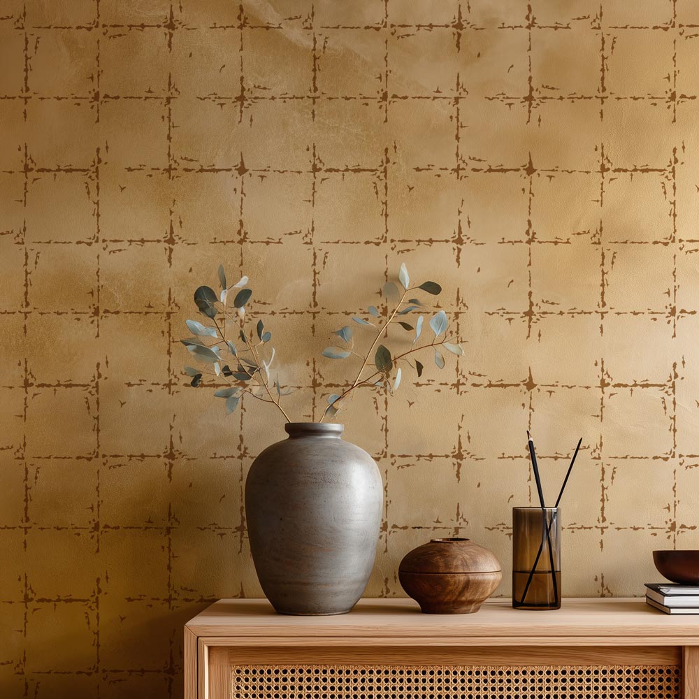 Decorative setting with vases and a plant against a stenciled golden wall