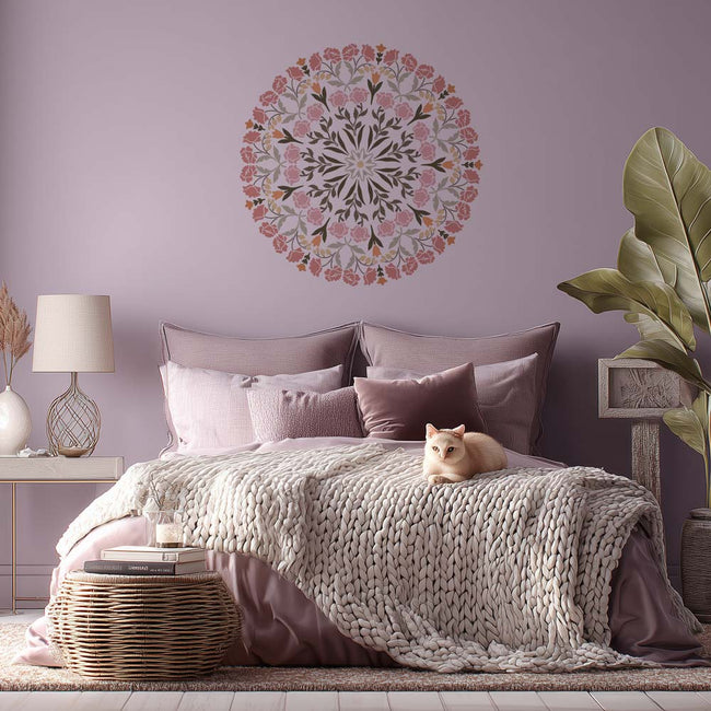 Cozy bedroom with a floral mandala wall stencil, bed with pillows, and cat.