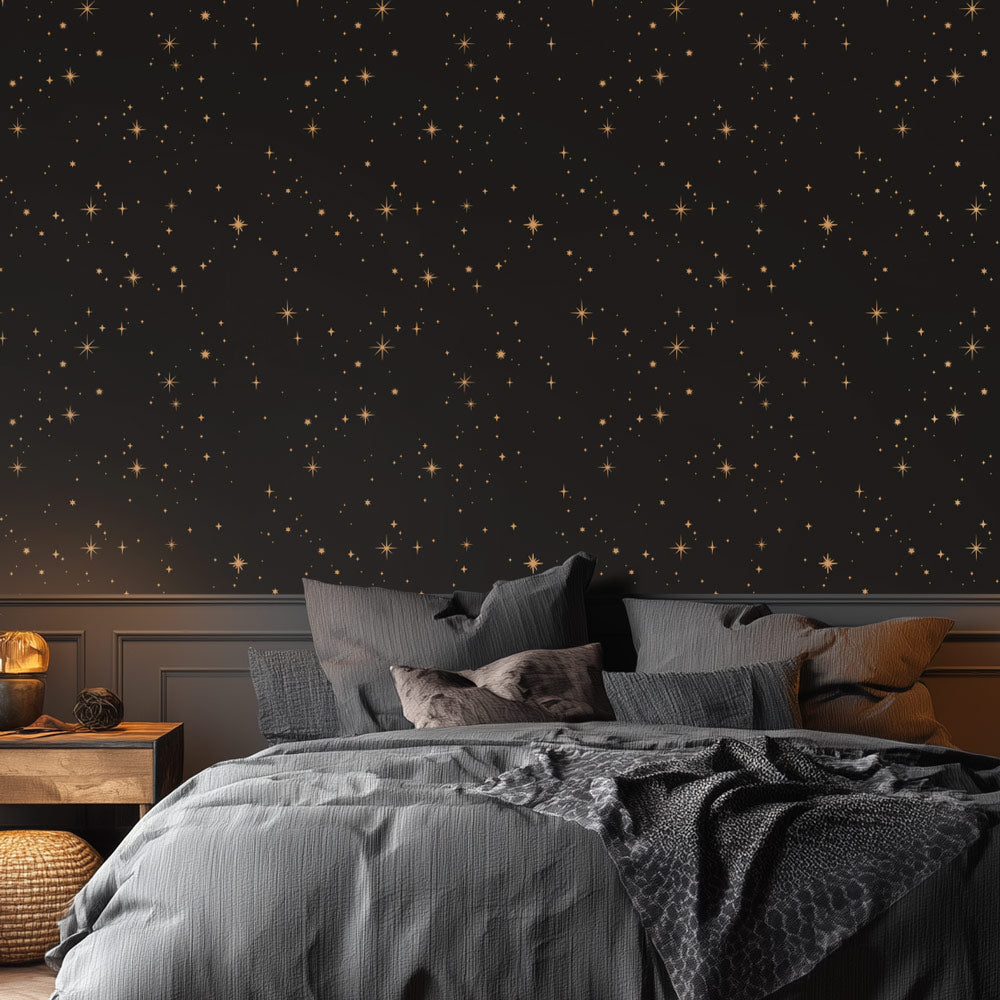 Bedroom with star-patterned stencil and gray bedding