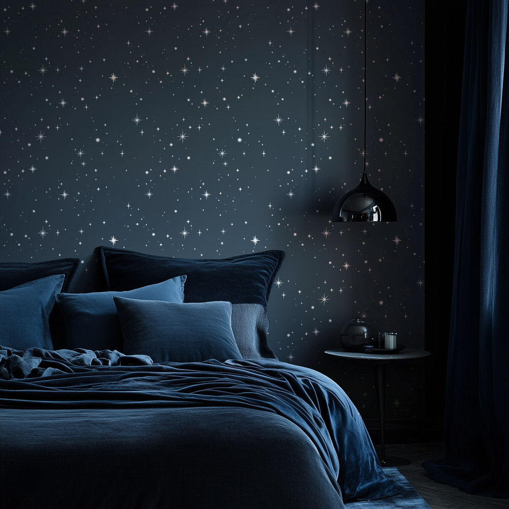 Bedroom with starry night wall stencil design and dark blue bedding.
