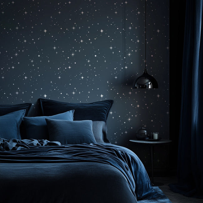 Bedroom with starry night wall stencil design and dark blue bedding.