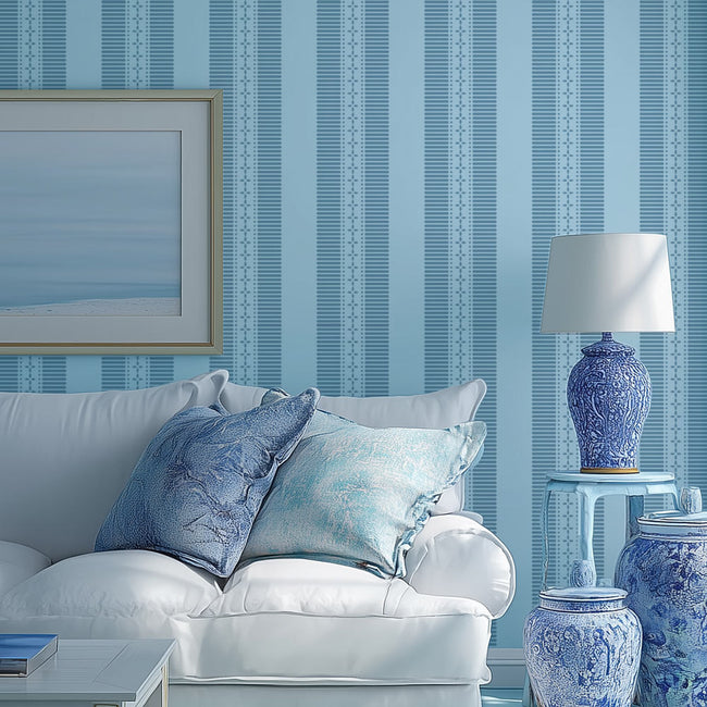 Living room with a white sofa, blue and white decor, and striped wall stencil.