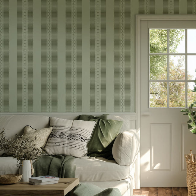 Living room with a white sofa, striped wall stencil, and a window with a view of trees.